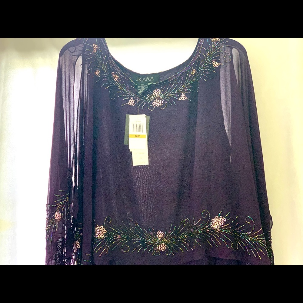 A plum full length cape sleeve gown. Never worn.